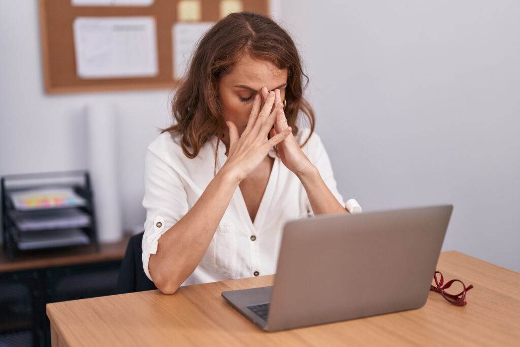 Woman business worker stressed using laptop at office